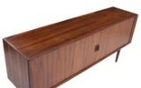 A rosewood sideboard, front with two sliding doors, mahogany interior with shelves and trays by 
																			 Faarup Mobelfabrik