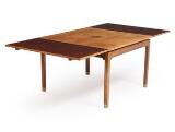 Square rosewood dining table with brass shoes and Dutch extension. by 
																			Harbo Solvsten