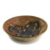 A circular stoneware dish, decorated in brown and bluish glazes by 
																			Poul Baekhoj