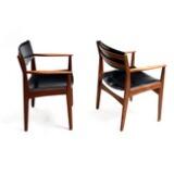 A pair of teak armchairs, upholstered in seat and back with black artificial leather by 
																			 Frem Rojle