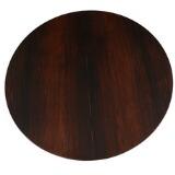 Circular dining table of rosewood with underlying folding leaf by 
																			 Jason Mobler