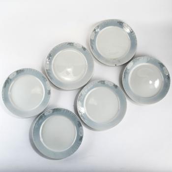 Six 'Marguerites' dining plates by 
																			Arnold Krog