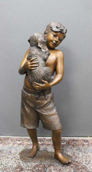 Large sculpture of a boy holding a dog by 
																			L Deane Trueblood