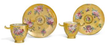 A pair of Sèvres gold-ground Etruscan cups and stands by 
																	Andre-Joseph La France