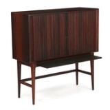 Bar cabinet of rosewood with tapering legs by 
																			 K P Mobler