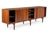 Rosewood sideboard, front with four sliding doors behind which adjustable shelves and trays by 
																			Henry Rosengren Hansen