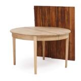 Circular solid oak extension table with two pine leaves by 
																			 Mikael Larsen