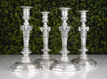 A set of four silver candlesticks by 
																	 Garrard