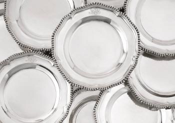 A set of twenty-four Edwardian silver dinner plates by 
																	 CS Harris and Sons
