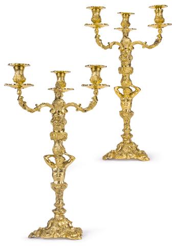 A pair of English silver-gilt three-light candelabra after a model by Paul de Lamerie by 
																	Paul De Lamerie