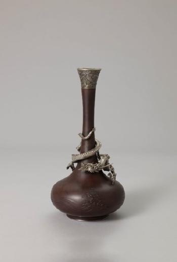 A hammered iron vase by 
																	 Katsu