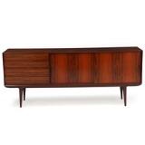 Sideboard of rosewood, Front with two sliding doors and four drawers by 
																			Gunni Omann