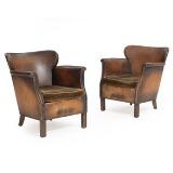 A pair of armchairs with stained beech legs by 
																			Otto Schulz