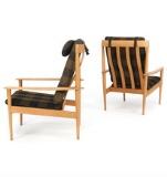 A pair of high back oak easy chairs, back with vertical slats by 
																			Grete Jalk
