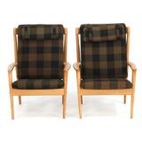 A pair of high back oak easy chairs, back with vertical slats by 
																			 P Jeppesen
