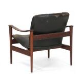 Easy chair of rosewood. Seat and back upholstered with black leather. Model 711 by 
																			Fredrik A Kayser