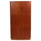 Corner cabinet of teak with three roll-fronts. Inside with adjustable shelves and trays by 
																			Kaj Winding