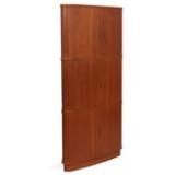 Corner cabinet of teak with three roll-fronts. Inside with adjustable shelves and trays by 
																			Kaj Winding