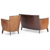 Two-seater sofa and easy chair upholstered with brown patinated leather with brass nails by 
																			Otto Schulz