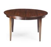 A circular rosewood extension table with three extra leaves one leaf with apron Model 55 by 
																			Gunni Omann