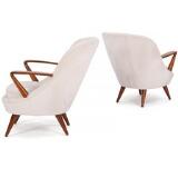 A pair of easy chairs of stained beech by 
																			K Racinowski