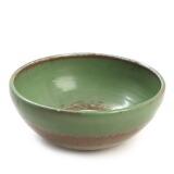 A earthenware bowl, decorated in green glaze by 
																			Jens Peter Dahl-Jensen