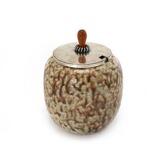 Stoneware marmelade jar decorated with brown spotted glaze with pale green elements by 
																			Hans Hansen