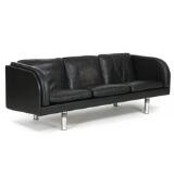 Freestanding three seater sofa mounted on round steel legs, Sides, back and loose cushions in seat and back upholstered with black leather by 
																			Erik Jorgensen