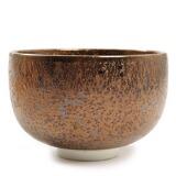 A Japanese porcelain teabowl, decorated with crystalline, golden glaze, in on short turned foot by 
																			Morino Taimei