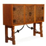 Cabinet of nutwood and oak with tall, profiled frame with sculptural brass stretchers by 
																			Otto Schulz