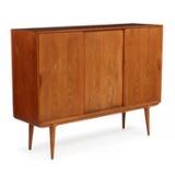 Tall sideboard of teak with three sliding doors, inside with shelves and pullout trays by 
																			 Omann Jun Mobelfabrik