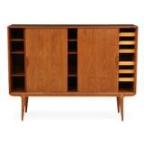 Tall sideboard of teak with three sliding doors, inside with shelves and pullout trays by 
																			Gunni Omann