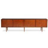 Sideboard of rosewood, front with four sliding doors. Inside with shelves and pullout trays by 
																			Henry Rosengren Hansen