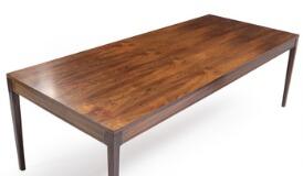 A rectangular rosewood work table with tapering legs and profiled rail by 
																			 Cado Co