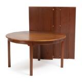 A circular teak dining table with four extension leaves, one with apron, one folding support leg by 
																			 P Lauritsen & Sons