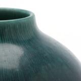 A large, round stoneware vase with incised vertical line decor by 
																			Eva Staehr-Nielsen