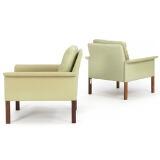 A pair of armchairs with rosewood legs by 
																			 C S Mobler