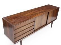 A rosewood sideboard front with four drawers and two sliding doors. Model 18 by 
																			Gunni Omann