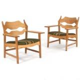 A pair of oak easy chairs by 
																			Henning Kjaernulf