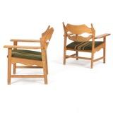 A pair of oak easy chairs by 
																			Henning Kjaernulf