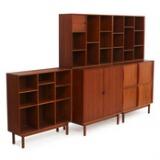 Wallunit of solid teak consisting of cabinet with tambour doors, cabinet with sliding doors and three bookcases by 
																			Peter Nielsen