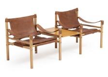 Scirocco, A pair of ashwood easy chairs and appertaining table, seat, back and armrests suspended with brown leather, loose cushions in seats with brown leather by 
																			Arne Norell