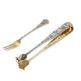 A Russian silvergilt and cloisonné enameled pair of tongues and a small fork by 
																			Feodor Ruckert