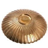 A circular patinated bronze dish, the outside cast with fluted pattern by 
																			 Tinos Bronce
