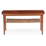 Coffee table of mahogany with shelf of woven cane and raised edge by 
																			Thorald Madsens