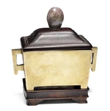 A Chinese cast bronze rectangular censer with pierced and edged handles by 
																			 Yu Tan