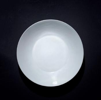 A Moulded White-Glazed'Dragon' Dish by 
																	 Kangxi