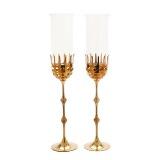 A Pair Of Brass Hurricane Candlesticks With Shades Of Clear Glass by 
																			Bjorn Wiinblad