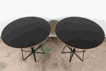 A pair of black rod and red laminate top paper clip tables by 
																			Lella Vignelli