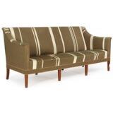 Three-seater sofa with eight tapering mahogany legs by 
																			Kaare Klint